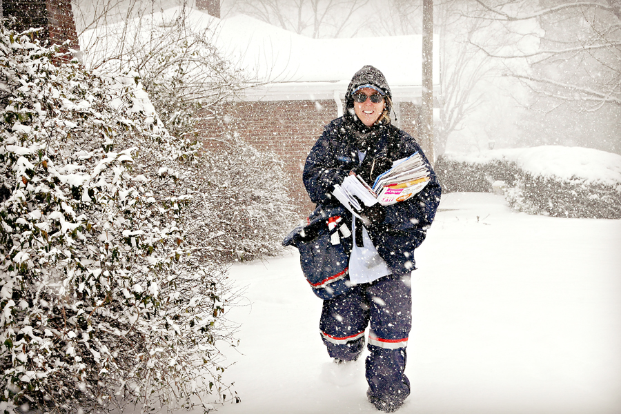 New Albany, IN, Letter Carrier Sharon McCaroll delivers mail at the beginning of a January blizzard.