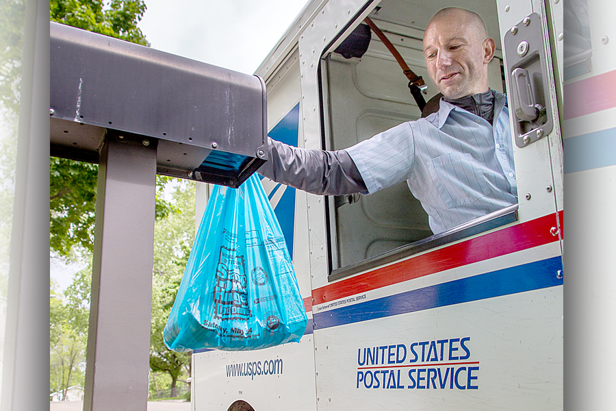 Madison, WI, Letter Carrier Enrico Przygoda collects donations during the Stamp Out Hunger food drive in May.