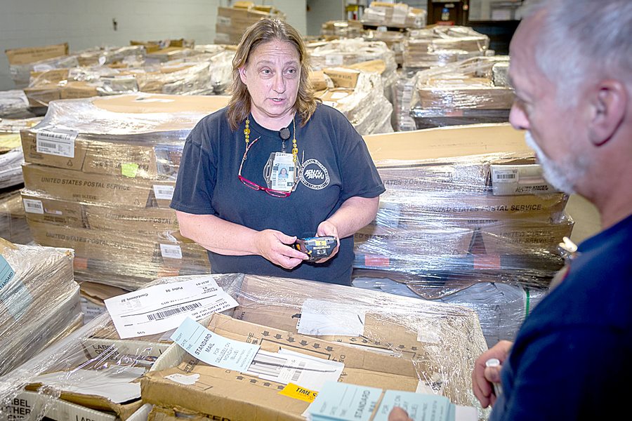 Mail Processing Clerk Mary Goldade scans a package.