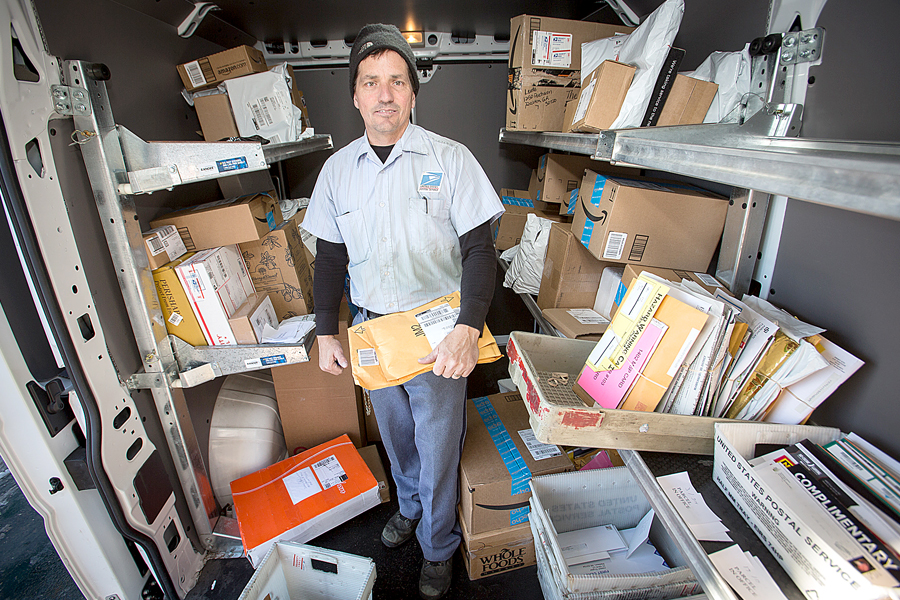 Madison, WI, Letter Carrier Tom Lukas sorting mail and packages