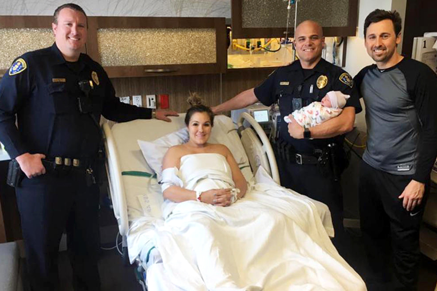 San Diego police officers Matt Enderlin and Eric Hustad, holding baby Pierce