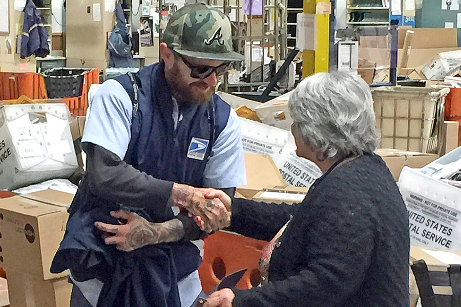 USPS employee shakes hands with supervisor