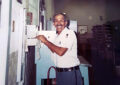 Man smiling in postal uniform