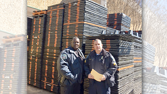 Two men stand in front of mailing equipment