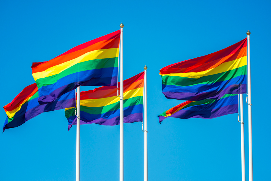 Five rainbow flags flying