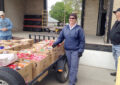Female carrier stands with boxed donations