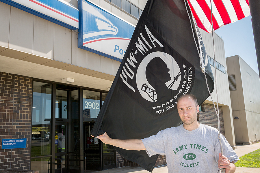 USPS employee prepares to raise POW-MIA flag