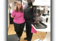 Woman and man stand next to mammorgram machine
