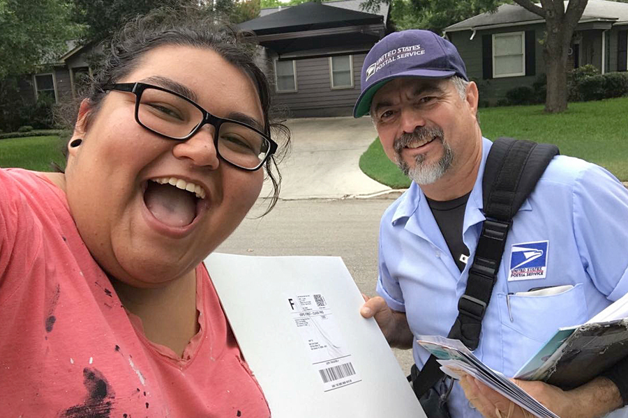 Woman poses for selfie with USPS letter carrier