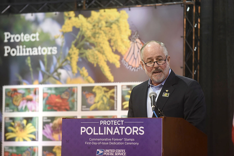 Val Dolcini, president and chief executive officer of the Pollinator Partnership, at podium