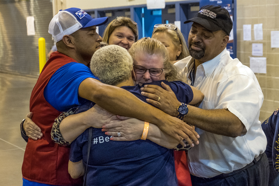 USPS employees in group hug