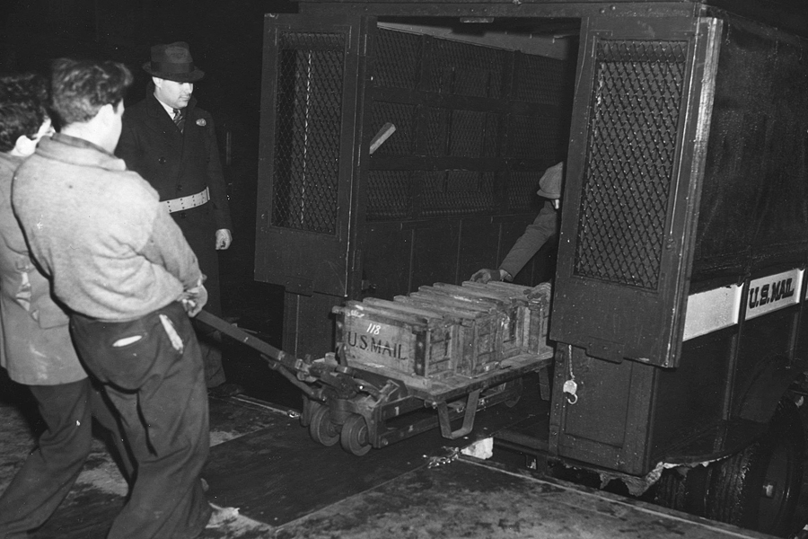 Men unload postal truck in 1937