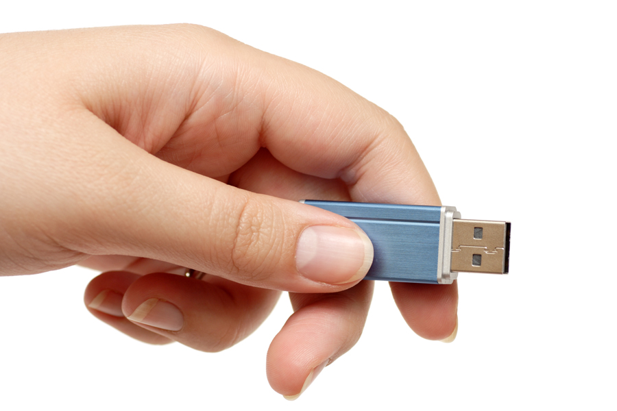 Hand holding a thumb drive
