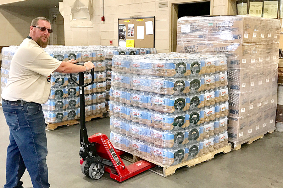 USPS employees pull pallet of water