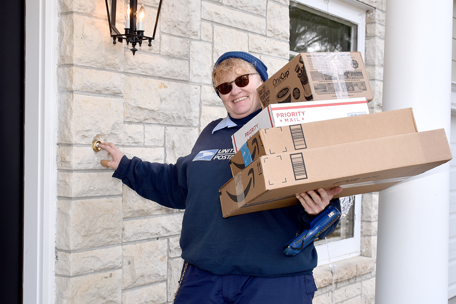 Letter carrier with armful of packages