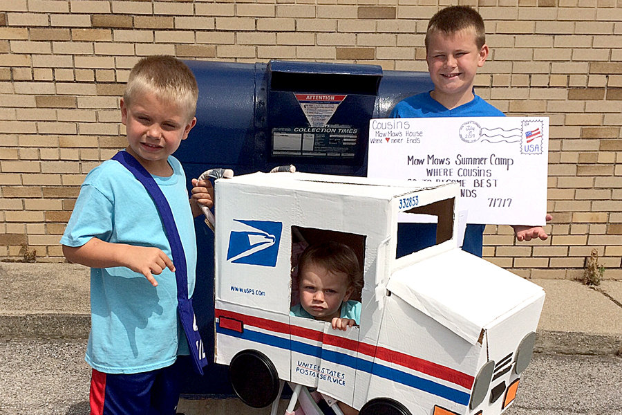 Children pose with miniature postal truck