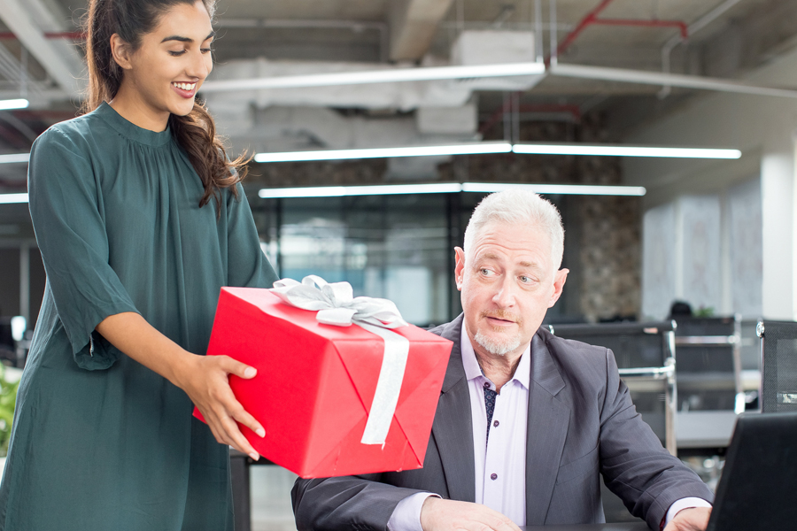 Woman presenting gift to a man