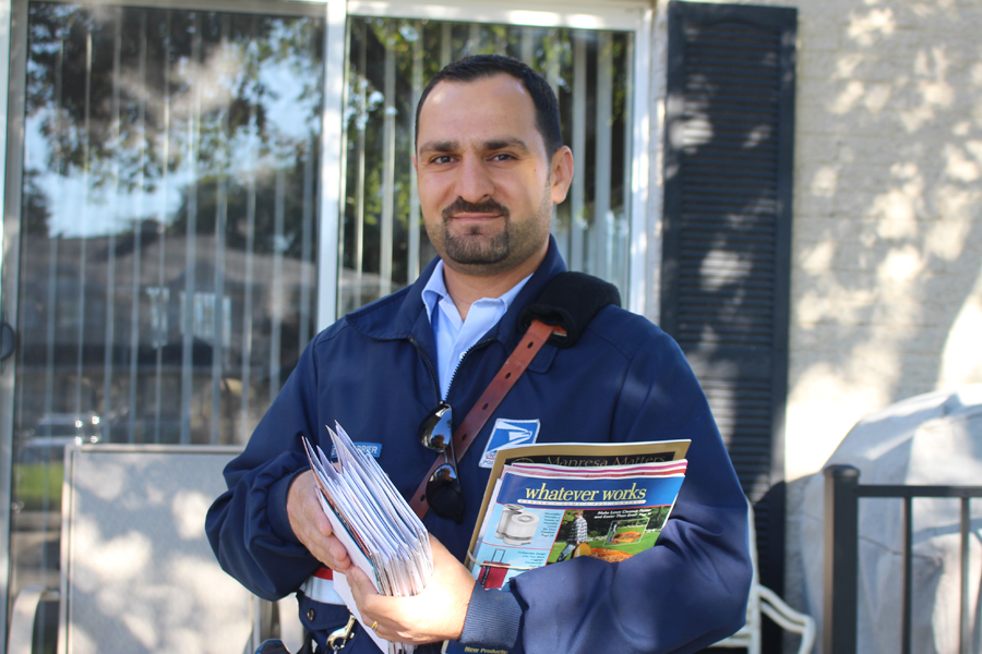 Letter carrier holds mail