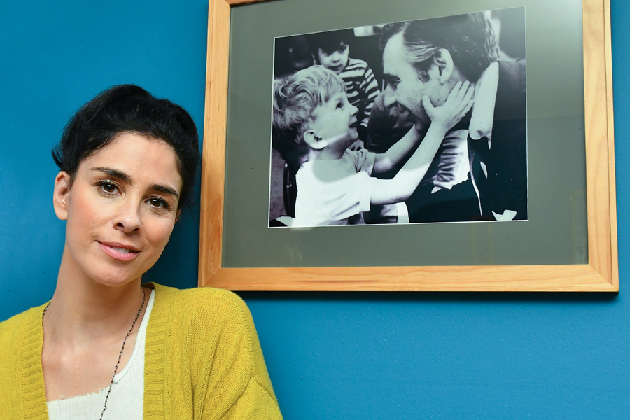 Sarah Silverman stands next to framed photo of Mister Rogers