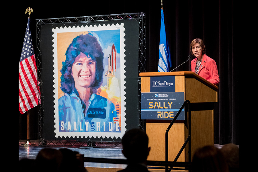 Sally Ride banner next to woman at podium