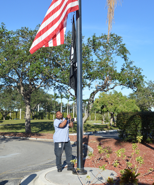 Employee raises POW-MIA flag