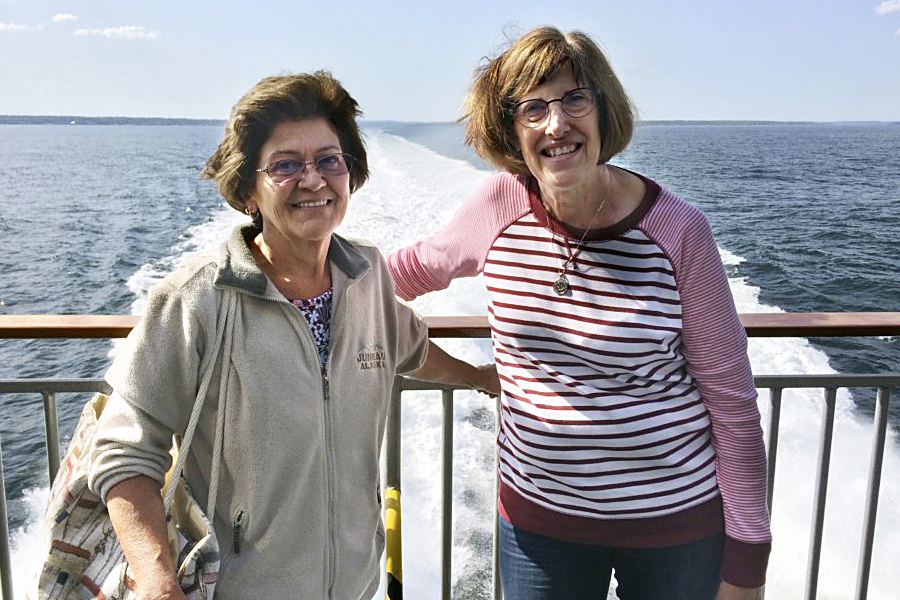 Women stand on ferry in ocean