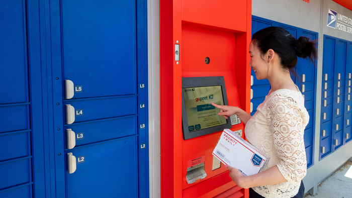 Customer prepares to leave a Priority Mail shipment at a gopost locker