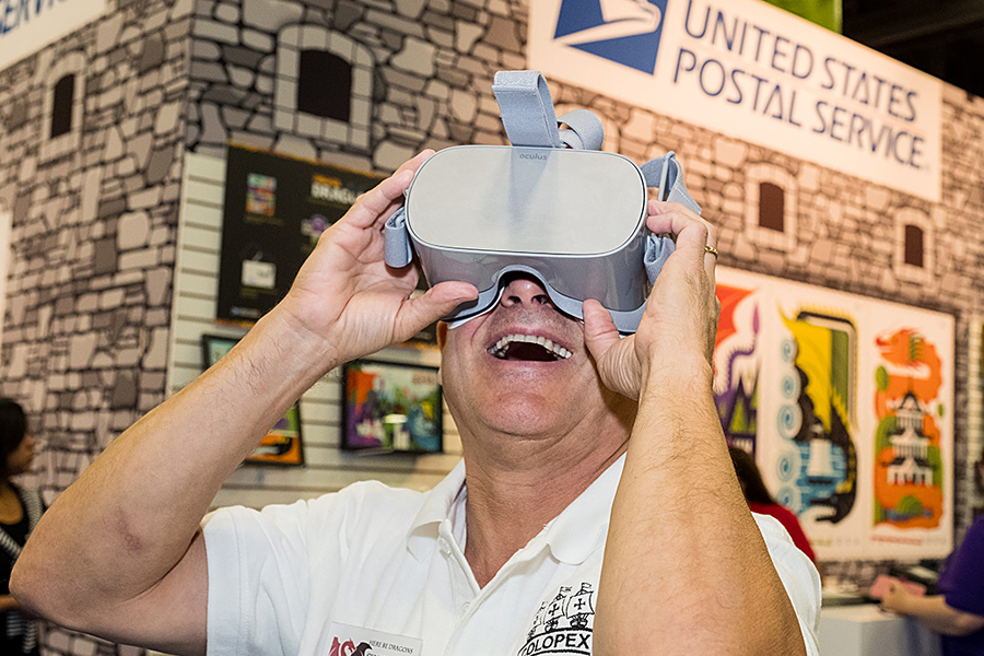 Man uses a virtual reality device at the Dragons stamp event