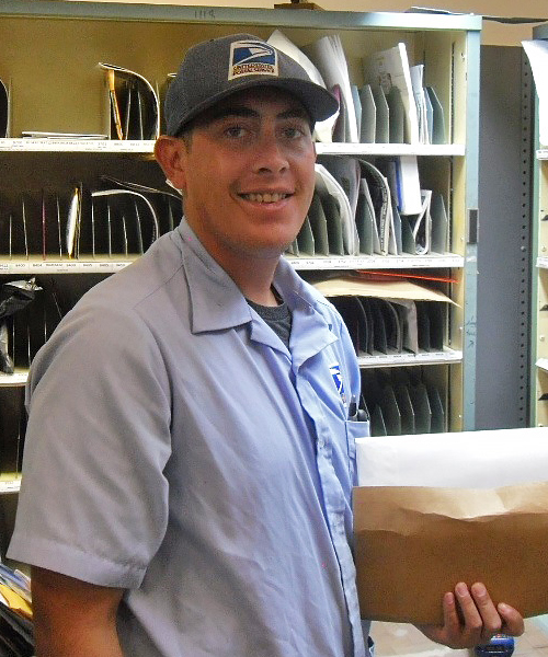 USPS employee holds package