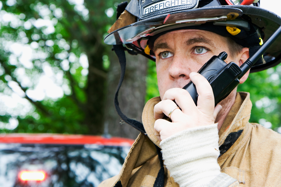 Firefighter talking into a radio