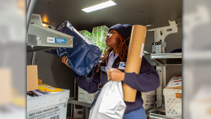 Letter carrier prepares to deliver packages