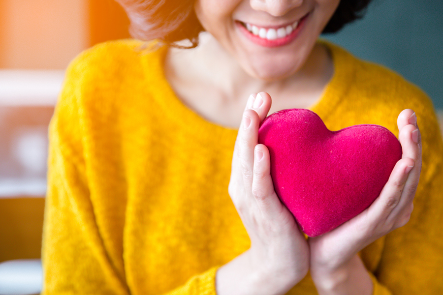 Woman holding a fabric heart