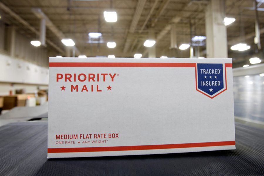 Priority Mail package moving on coveyor belt in USPS workroom