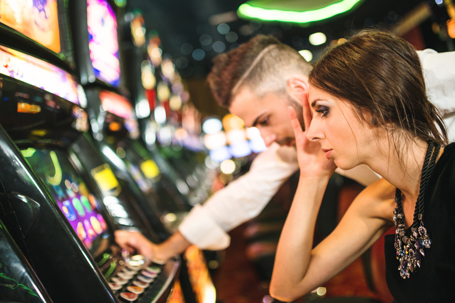 Gamblers at a slot machine