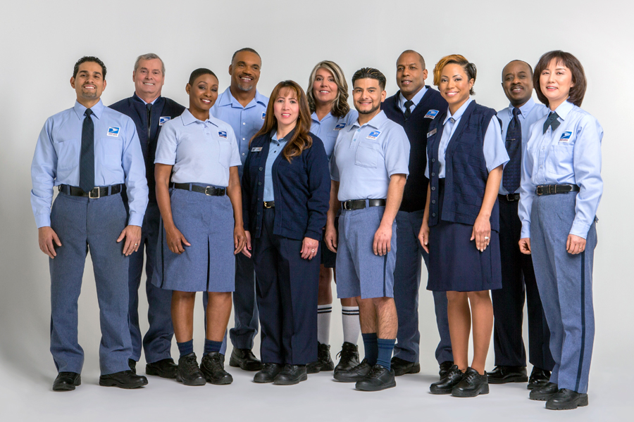A group of Postal Service employees wearing uniforms