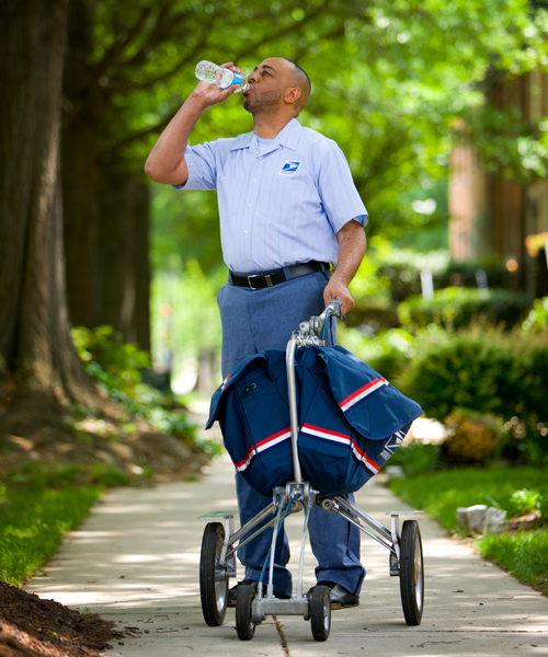 Postal employee drinks water.