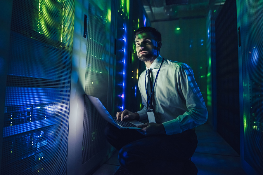 Man works in shadowy data center