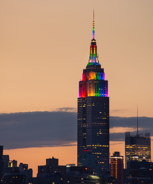 The Empire State Building in New York City illuminated with rainbow colors
