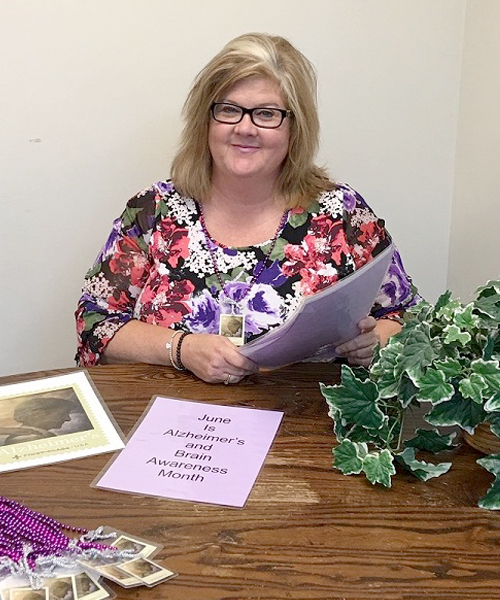 Kim Reynolds, a customer relations coordinator in Peoria, IL, reviews materials