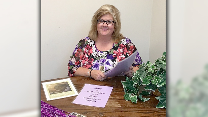 Kim Reynolds, a customer relations coordinator in Peoria, IL, reviews materials