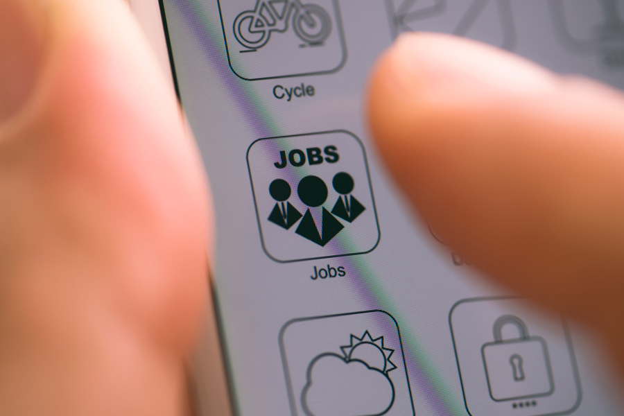 Employee uses finger to tap jobs app on mobile device