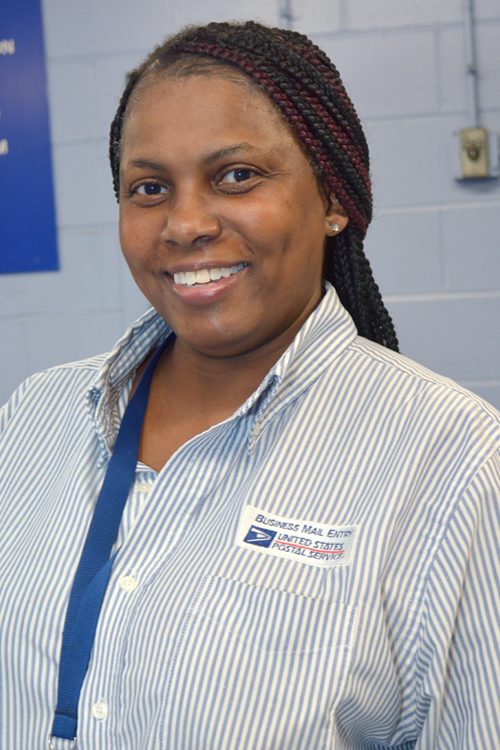 Smiling woman in postal uniform