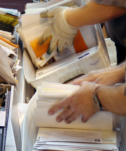 Workers hands sorting mail