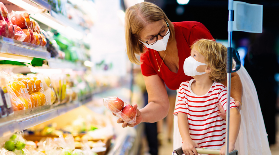 Woman shopping in supermarket with child