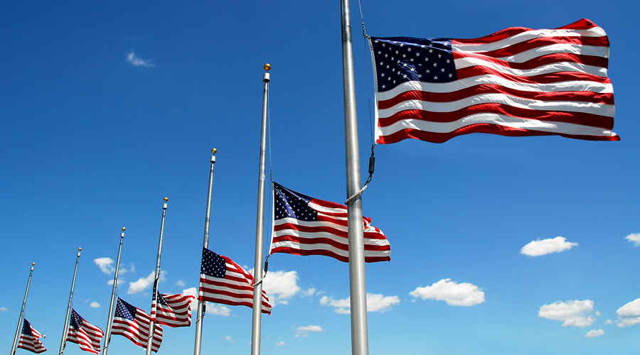 U.S. flags flying at half-mast