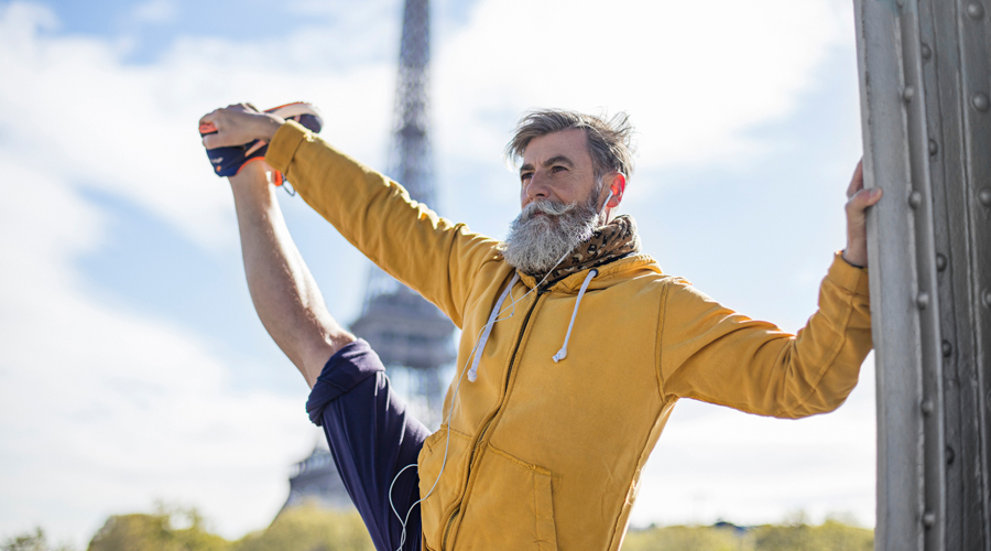 Fit man stretches near Eiffel Tower