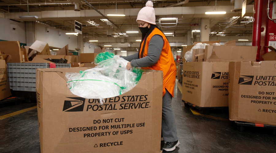 Postal worker recycles plastic wrap.